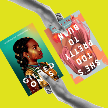 two hands, each holding books book 1 is she's too pretty to burn, by wendy heard book 2 is the gilded ones by namina forna